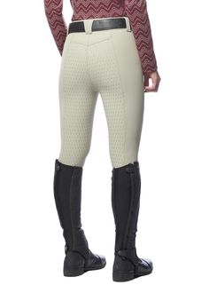 a woman in riding pants and boots