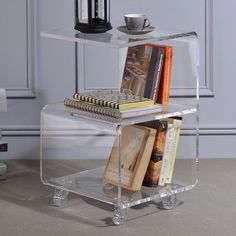 a clear acrylic shelf with books on it