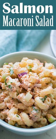 a white bowl filled with macaroni salad on top of a table next to a blue towel