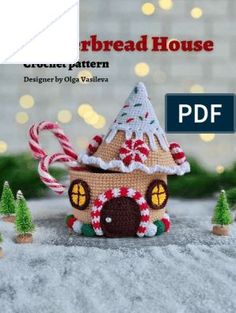 a crocheted house with candy canes and trees