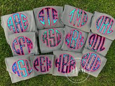 six monogrammed pillows on the grass