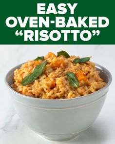 a bowl filled with risotto and topped with sage leaves, on top of a white counter