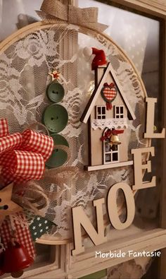 a close up of a wooden sign on a window sill with buttons and bows