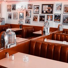 a restaurant with red booths and pictures on the wall