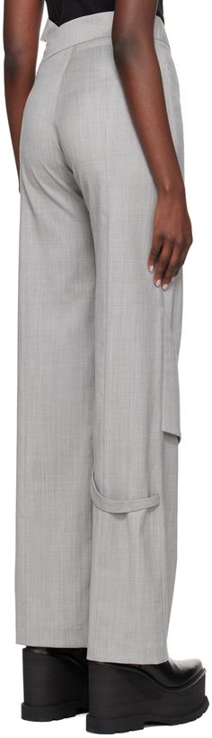 Wool delaine trousers. · Strap at asymmetric waistband · Two-pocket styling · Zip-fly · Fixed strap at front and back knee · Concealed zip vent at cuffs Supplier color: Light grey Asymmetrical Bottoms For Formal Spring Occasions, Asymmetrical Bottoms For Spring Formal Events, Asymmetrical Bottoms For Spring Formal Occasions, Spring Formal Asymmetrical Bottoms, Asymmetrical Bottoms For Workwear In Fall, Elegant Asymmetrical Bottoms With Pockets, Heliot Emil, Top Brands, Light Grey