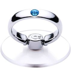 a ring with a single diamond on it sitting on top of a clear display plate