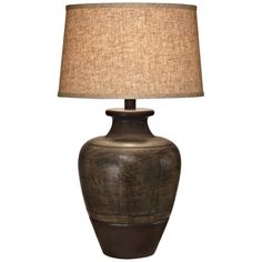 a brown table lamp with a beige shade on the base and a white linen lampshade