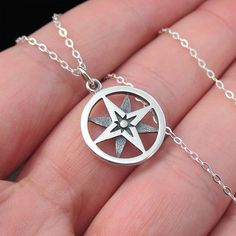 This necklace features a round openwork sterling silver north star compass charm on a delicate sterling silver chain. The compass has long been considered a good luck charm and a symbol of protection and guidance while the North Star represents inspiration, hope, and limitless possibilities. Pendant Diameter 15 mm Chain Type Cable Chain Width 1.3mm Clasp Type Spring Ring Chain Length 16,18,20" Metal Sterling Silver Color Sterling Silver Metal Purity 925 Production Time 2-3 Business Days Sterling Silver Star Charm Necklace, Silver Medallion Charm Necklace With Compass Design, Sterling Silver Star-shaped Jewelry With Compass Design, Silver Star-shaped Necklace With Compass Design, Symbolic Sterling Silver Jewelry With Compass Design, Sterling Silver Medallion Jewelry With Star Charm, Symbolic Sterling Silver Necklace With Compass Design, Symbol Of Protection, The North Star