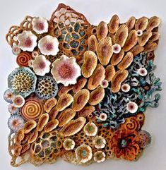 an art piece made out of clay and shells