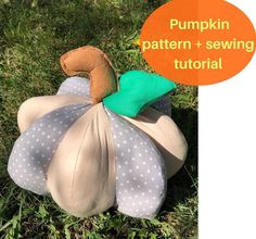 a stuffed animal sitting on top of a pillow in the grass with a pumpkin pattern and sewing instructions below