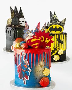 two cakes decorated to look like batman and supermans