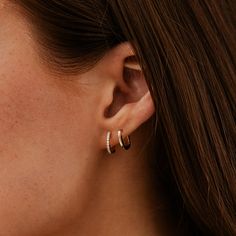 Our DRD Huggies are the quintessential gold and diamond huggie earrings. Sized at 10.5mm in length, they are dainty, delicate, and oh so sparkly with 0.13ctw of white pavé set round diamonds set in 14 karat gold. Essential for any ear stack, the DRD Huggies are one of our most popular and sought-after styles. Our beloved diamond huggies pair well with anything from diamond hoop earrings to a stud to a statement earring. At 10.5mm, they are a touch larger than our Mini Huggies, which are 9mm in length for comparison. For those needing a wider opening, try our DRD Medium Huggies. Wear diamond huggies alone for a simple statement or stack a few together for a dramatic ear statement. 14 Karat Gold 0.13 Total Diamond Carat Weight 10.5mm in length and 1.3mm in width Diamonds are G/H Color and SI Everyday White Gold Huggie Earrings With Single Cut Diamonds, Classic Everyday Huggie Earrings With Pave Setting, Everyday Huggie Earrings With Brilliant Cut, Minimalist Brilliant Cut Diamond Huggie Earrings, Everyday White Gold Huggie Earrings With Diamond Accents, Everyday Diamond White Huggie Earrings With Brilliant Cut, Minimalist Huggie Diamond Earrings With Brilliant Cut, White Gold Huggie Earrings For Everyday Luxury, Minimalist Huggie Earrings With Pave Setting For Anniversary