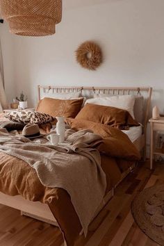 a bed sitting in a bedroom on top of a wooden floor next to a window