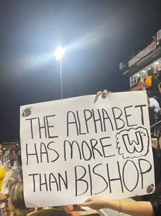 a person holding up a sign that says the alphabet has more wf than bishop