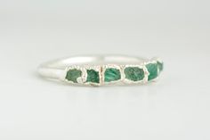 999 Fine Pure Silver Deep Dark Green Rough Raw Emerald Band Ring // Emerald Ring // Emerald Band // Rough Emerald Ring // Raw Emerald Ring This listing is for one tiny fine silver green Emerald band ring. No copper, no nickel, allergy free. Suitable for people with sensitive skin. DETAILS: Stone: natural semi-transparent quality rough emerald Metal: 925 silver, electroformed in 999 silver and oxidized black or plated with 18k rose gold, 24k yellow gold or rhodium (white gold effect), if chosen. Green Crystal Stone Ring For Anniversary, Green Emerald Ring With Stones, Green Crystal Ring With Stones For Anniversary, Green Stone Jewelry For Promise Ring, Unique Green Stackable Promise Rings, Green Sterling Silver Stackable Emerald Ring, Green Sterling Silver Stackable Jewelry, Handmade Green Stackable Rings For May Birthstone, Anniversary Emerald Rings With Stones