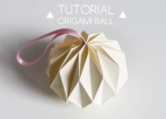 an origami ball with pink ribbon on the side and text overlaying it