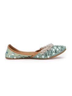 Mint handcrafted juttis with all-over Mirror with embellishment of silver ghungroos. Color: Mint Fabric: Upper: Intricate mirror embroidery Insole - Leather Sole - Vegetable tanned Leather Sole Note: Available in other colors The product will be shipped within 20-25 days of the order placed Any slight irregularities are distinctive and are inherent to the beauty of this creation as it is precisely crafted by hands. Care intructions - Keep in dust bag, dry clean only, embellished accessory needs Festive Party Flats With Cutdana, Bollywood Style Closed Toe Flats With Mirror Work, Festive Mirror Work Closed Toe Flats, Navratri Closed Toe Flats With Mirror Work, Festive Diwali Flats With Mirror Work, Bollywood Style Festive Flats With Mirror Work, Festive Embellished Closed Toe Flats, Festive Embellished Closed-toe Flats, Bollywood Style Party Flats With Mirror Work