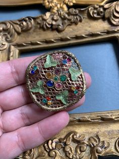 Andriani Vintage is pleased to offer for sale this wonderful brooch pin. Art Deco Czech Design Multi colour paste rhinestones and green enamel painted leaves on gold filigree work Round in shape In lovely condition MEASUREMENTS 4.5cms diameter Great item at a great affordable price.A real must have for collectors and fashionistas alike.Please check out my other items including more vintage Czech pieces in my Etsy shop at:http://www.etsy.com/uk/shop/AndrianiVintage Handmade Vintage Brooches For Vintage Events, Antique Jeweled Brooches As Gift, Victorian Jeweled Brooches As Gift, Victorian Style Multicolor Brooches As Gift, Vintage Filigree Brooches, Handmade Vintage Enamel Pin, Ornate Jeweled Brooches For Gifts, Vintage Jeweled Brooches As Gifts, Ornate Jeweled Brooches As Gifts