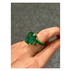 Make a statement with this three stone cocktail ring, with 19.69 carat center stone Zambian Emerald with 2.01 carat side-stone Emeralds. All set in 18K Yellow Gold. The unique feature of this ring is the beautiful green enamel on the band. Currently sized at US7, can be resized - but this will take 3 weeks, as we will have to remake the ring. Certificate available. Please feel free to message us for more information. We provide free shipping, and accept returns. Emerald Engagement Ring Unique, Green Emerald Ring, Zambian Emerald, Emerald Engagement Ring, Green Enamel, Three Stone Rings, Zambia, Emerald Ring, Unique Engagement Rings