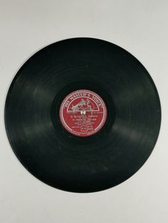 an old record that has been placed on the wall in front of a white background