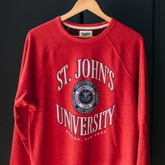 Inspired by vintage St. John’s gear you might’ve seen on the F train back in the day, we put our spin on a classic, collegiate crewneck. While the university is most commonly associated with Queens, where you’ll find its main campus, the university was founded in Brooklyn and expanded into Queens in 1954. As time progressed, the small university made a name for itself beyond its size, further opening campuses across the city. Products are mocked up on a size S. Graphics may appear smaller on lar University Logo Sweatshirt For Campus, University Logo Sweatshirt For College, Collegiate Sweatshirt With University Logo, Collegiate Crew Neck Top For Campus, Sporty University Red Crew Neck Sweatshirt, University Red Varsity Crew Neck Sweatshirt, University Red Varsity Sweatshirt With Crew Neck, Sporty University Logo Sweatshirt For Campus, University Red Collegiate Crew Neck Sweatshirt