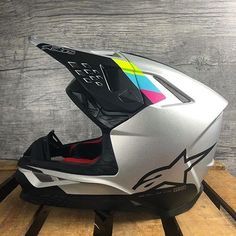 a helmet is sitting on top of a pallet in front of a wooden wall