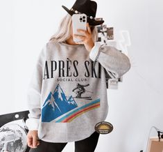 Après Ski Sweatshirt" is the perfect cozy addition for those post-slope gatherings or winter festivities. Whether you're at a ski resort, a mountain getaway, or a bachelorette party in Aspen, this sweatshirt brings style and warmth. Ideal for ski-themed parties, camp bachelorette weekends, or simply lounging by the fireplace after a day in the snow, it's a must-have for any winter adventure. Embrace the fun of the season with this stylish après-ski sweater that captures the spirit of snowy mount Long Sleeve Ski Tops For Ski Season, Long Sleeve Skiing Tops For Ski Season, Long Sleeve Tops For Ski Season And Winter Sports, Long Sleeve Tops For Ski Season, Ski Bachelorette, Mountain Bachelorette, Apres Ski Sweater, Ski Wedding, Ski Sweatshirt