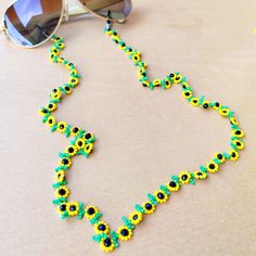 This handmade sunflower jewelry for women is meticulously hand-woven from the finest glass seed beads. Handmade beadwork, eyeglass chain is lightweight and comfortable to carry, so your glasses will not be lost. Lenght 80 cm 31,5 inches The fashion sunflower eyeglass necklace, which is suitable for every outfit and can be used in every season, is the ideal style gift eyeglass chain for you and your loved ones. Guaranteed to receive all compliments. It's not just an eyeglass chain! it is also sunflower necklace, wrap bracelet, cute reading glasses and multi-purpose beaded eyeglasses chain. You can click the link for my other handmade beadwork jewelry and accessories! https://yasminjewelrygifts.etsy.com If there is a color and pattern you want, I will do it for you, you can write a message. Handmade Flower Beaded Necklace For Summer, Summer Flower Beaded Necklace Handmade, Handmade Summer Flower-shaped Beaded Necklace, Handmade Yellow Beads For Summer, Summer Beaded Glass Necklaces For Gifts, Handmade Green Glasses Chains With Round Beads, Summer Glass Beaded Necklaces For Gifts, Summer Gift Glass Beaded Necklaces, Summer Glass Beaded Necklaces As Gifts