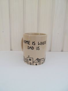 a coffee mug with the words home is where dad is