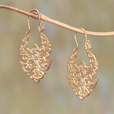 Realized in brass bathed in 18k gold angelic openwork patterns are displayed in drop earrings from Bali. By Komang Budiarta they are named Alam meaning nature in Bahasa Indonesia. Intricate Brass Hoop Earrings, Delicate Gold Jewelry For Festivals, Ornate Bronze Earrings, Elegant Filigree Hoop Earrings For Festivals, Bronze Filigree Jewelry, Ornate Pierced Brass Chandelier Earrings, Ornate Brass Chandelier Pierced Earrings, Ornate Brass Chandelier Earrings, Ornate Chandelier Earrings With Ear Wire