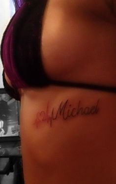 the back of a woman's stomach with her name tattooed on it