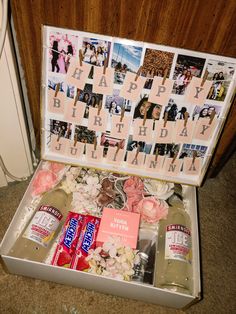 an open suitcase filled with personalized items and pictures on the front, along with flowers