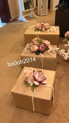 three boxes with flowers and pearls on them