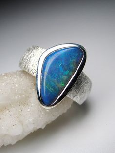 Black Opal silver ring opal origin - Australia  opal measurements - 0.16 х 0.27 х 0.59 in / 4 х 7 х 15 mm ring weight - 8.75 grams ring size - 7 US ref No 11307 Worldwide shipping from Berlin, Germany. Prices include all taxes, valid in Germany and in European Union countries on the Customer's order date. Price does not include import taxes and custom duties. It is the Customer's full liability to pay any possible customs duties, import taxes or other applicable and due by the concerned country' Blue Opal Round Ring, Blue Round Opal Ring, Blue Opal Promise Ring, Blue Cabochon Opal Ring In Sterling Silver, Blue Opal Open Ring In Sterling Silver, Blue Opal Rings For Anniversary, Modern Opal Ring For Anniversary, Blue Opal Anniversary Rings, Blue Sterling Silver Polished Opal Ring