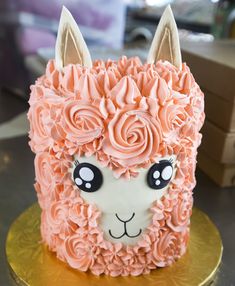 the cake is decorated with an animal's face and flowers on top of it