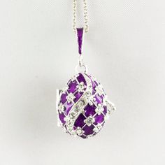 "Inspired by Faberge jewelry, egg shaped sterling silver locket enameled both outside and inside with an angel surprise, designed and made in our NJ shop. The surface of the pendant is covered with the rich purple enamel and Swarovski crystals are set in the center of the tiny 4-petal flowers. The egg is 20 mm (0.7\") long without a bail for a chain. It will come with 18\" sterling silver chain and in a gift box. We make this locket in a variety of colors, with gold plating and without, please, Purple Locket, Red Flower Necklace, Bouquet Jewelry, Faberge Jewelry, Faberge Egg, Angel Charm, Sterling Silver Locket, Silver Locket, Rich Purple