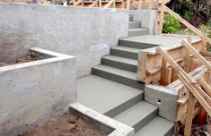 concrete stairs being built on the side of a building