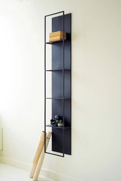 a baseball bat leaning up against a wall with a bookcase in the corner next to it