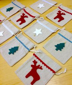 christmas decorations made out of fabric hanging on a table