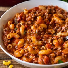 a white bowl filled with pasta and meat