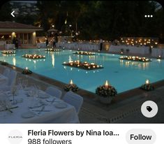 an outdoor wedding reception with candles lit up in the pool and tables set for dinner