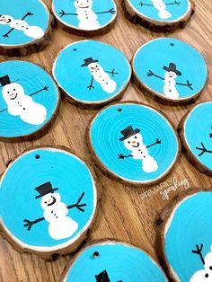 wood slices with painted snowmen on them