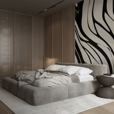 a bed sitting in the middle of a bedroom next to a wall with zebra print on it