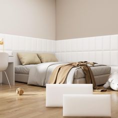 a white bed sitting in a bedroom next to a desk and chair on top of a hard wood floor