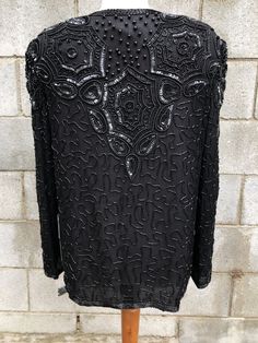 Fabulous Papelle Boutique vintage black sequined & beaded jacket. In MINT condition, has never been worn & still has tags attached! From 1970s-1980s Shell 100% SILK Made in India ♥MEASUREMENTS♥ Bust: 40 inches Waist: 40 inches Length (Top shoulder to bottom hem): 26 inches Shoulder to shoulder: 17 Inches across Sleeve: 23 inches **FREE SHIPPING TO UNITED STATES Vintage Black Embellished Outerwear, Vintage Beaded Evening Outerwear, Vintage Black Outerwear For Party, Beaded Long Sleeve Evening Outerwear, Floral Lace Blouse, Beaded Jacket, Mens Black Leather, Nov 6, Lace Tank Top