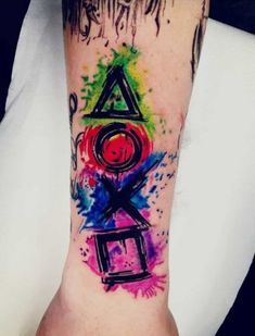 a colorful tattoo on the arm with letters and numbers painted on it, all in different colors