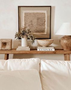 a wooden table topped with books and vases