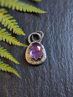 Recycled sterling silver chunky amethyst pebble pendant. I made this pendant using off cuts of sterling silver melted down and hammered flat. The shape is organic and freeform. The rose cut amethyst is set in a scalloped bezel with a hammered spot texture.  Oxidized to give a antique finish.  Measures 2.6cm  H 1.5 cm W The pendant is sold without a chain these can be purchased separately in my shop if needed. Healing Hand Forged Sterling Silver Necklace, Hand Forged Sterling Silver Healing Necklace, Unique Hand Forged Purple Necklaces, Nature-inspired Purple Sterling Silver Jewelry, Hand Forged Purple Pendant Necklace, Hand-forged Purple Pendant Necklace, Purple Sterling Silver Necklace With Large Pendant, Handmade Amethyst Teardrop Pendant Necklace, Hand Forged Amethyst Pendant Necklace