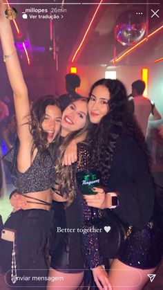 three girls are posing for the camera at a party with their arms in the air