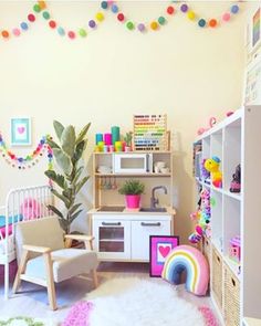 a child's playroom with toys and decorations on the walls, including a potted plant